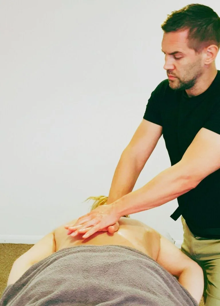 Certified Sports Massage Therapist, performing a sports massage on a client in Hockley, Essex